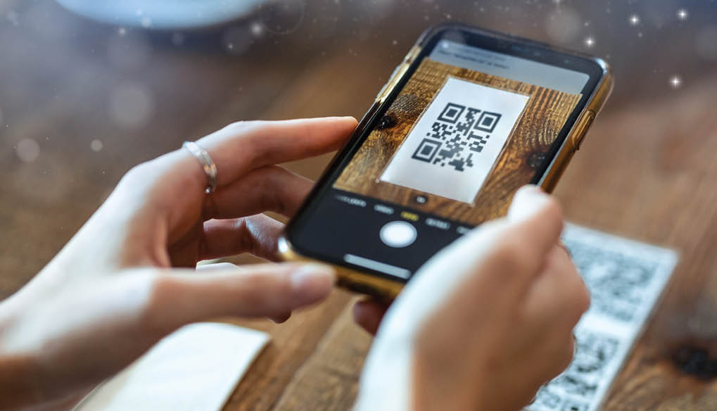 Hand Scanning QR code, E-Wallet, online payment, credit card, bank app, cashless payment concepts, Woman hand scanning QR code using smartphone